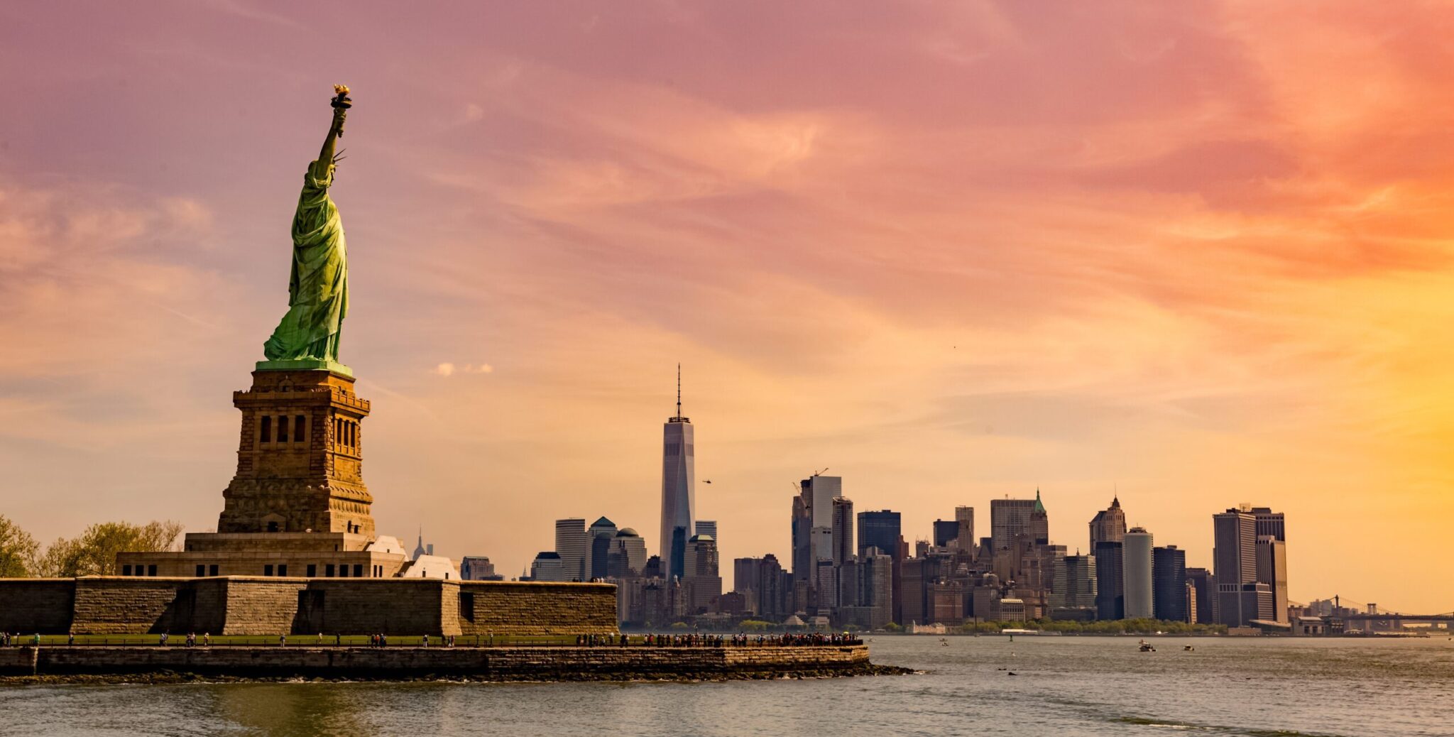 A beautiful picture of a statue of liberty national monument under the mesmerizing sunset in New York City, USA